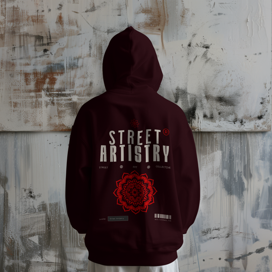 Model wearing Street Artistry hoodie showing back design against textured wall.