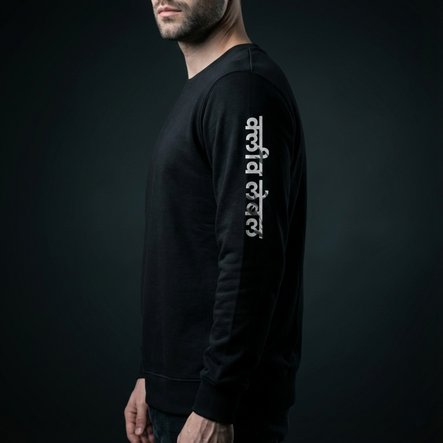 Model wearing a black long-sleeve shirt with logo on a dark background