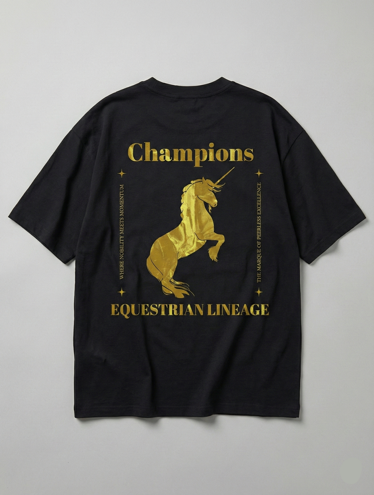 Flat lay of black tee with gold horse and Champions typography.