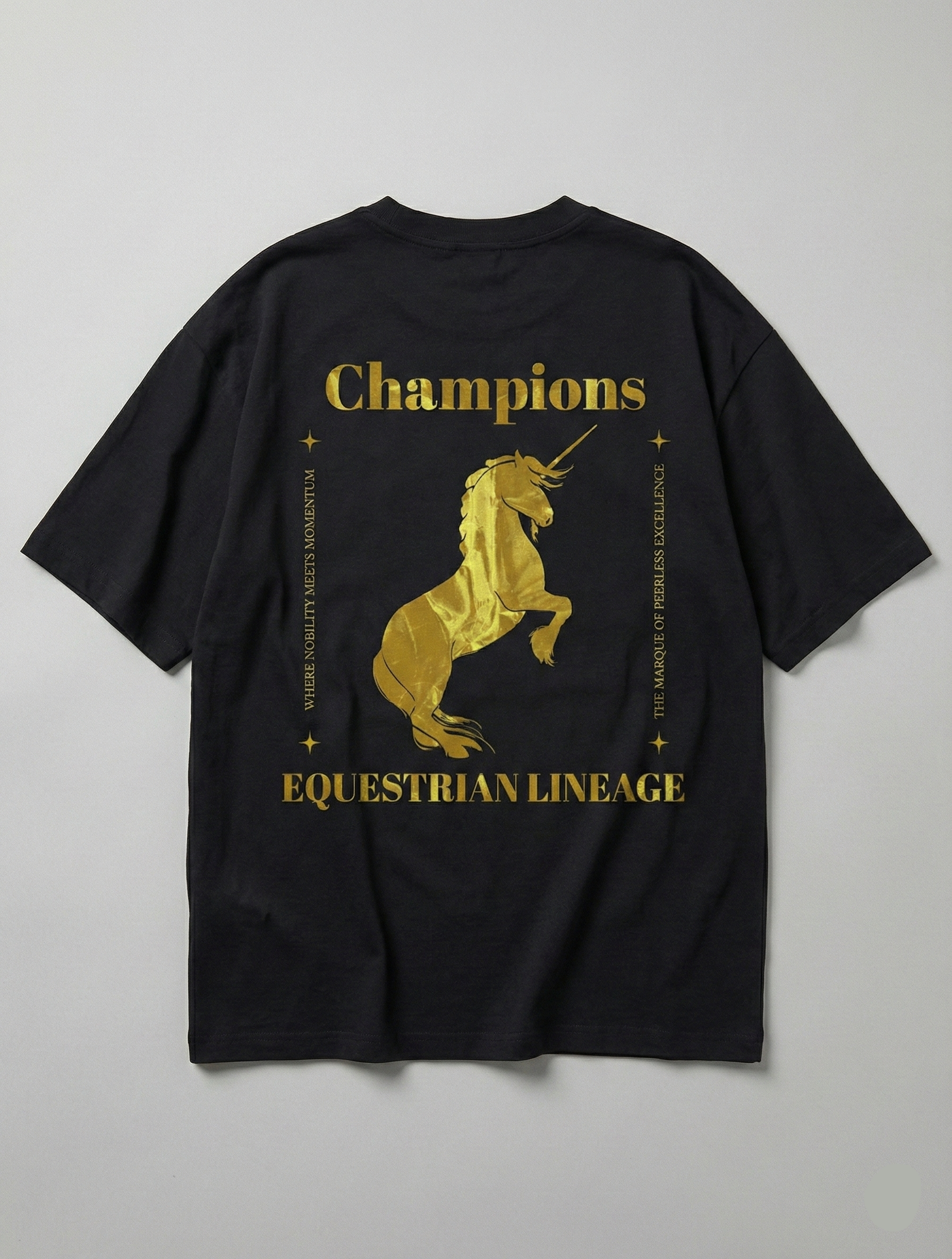 Flat lay of black tee with gold horse and Champions typography.
