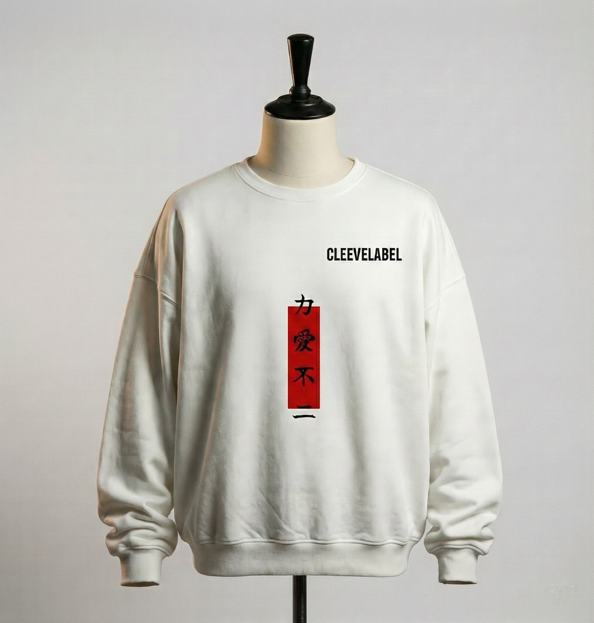 White Cleevelabel warrior oversized sweatshirt front view on mannequin with vertical red kanji design, clean soft studio lighting.